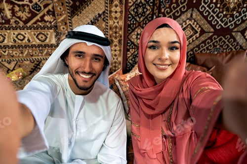 Preview: Young couple from Emirati spending time in a cafe