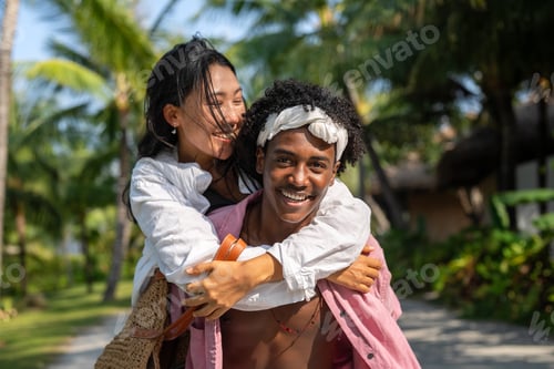 Preview: Carefree couple enjoying a tropical beach vacation, laughing making unforgettable memories together