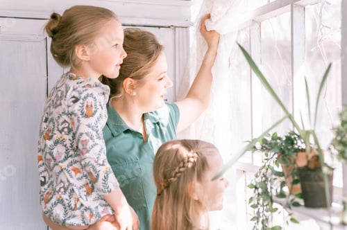 Preview: family mother with daughters have fun in suburb countryside home life. mom and kids by the window