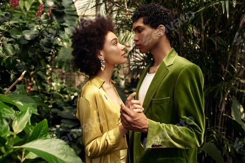 Preview: Loving couple gazes deeply in a lush greenhouse filled with vibrant greenery and life
