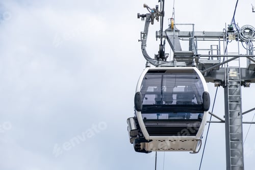 Preview: Close-up of a cable car cabin against the sky.