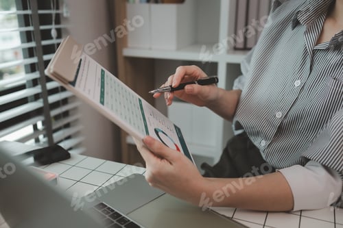 Preview: businesswoman working on laptop in her studio, businessperson working on a digital tablet and laptop