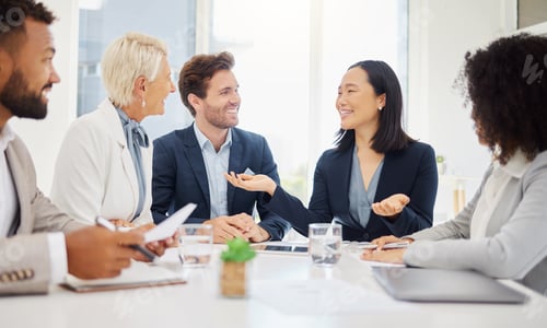 Preview: Confident young asian businesswoman explaining plans and ideas to her diverse colleagues during a m