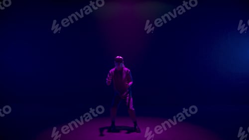 Preview: Vr man gesturing game in neon lights room. Blonde player use headset controllers