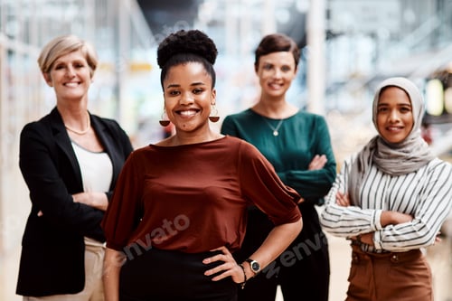 Preview: Portrait of a young businesswoman standing in an office with her colleagues in the background