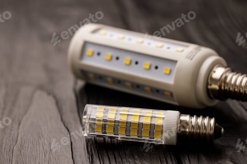 Preview: Light bulbs on dark wooden background close up