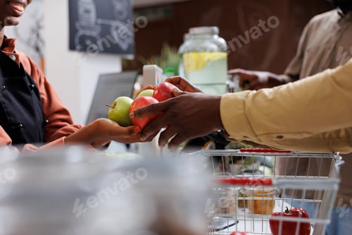 Preview: Vendor and customer holding apples
