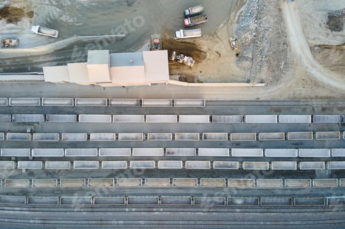 Preview: Aerial view of cargo train loaded with crushed stone materials at mining factory. Railway