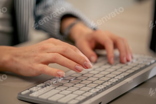 Preview: close-up of female young hands typing on white keyboard office device nude manicure professional