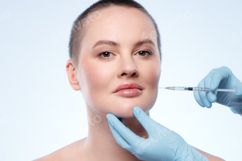 Preview: Beautiful woman with short hair gets a beauty injection in her face