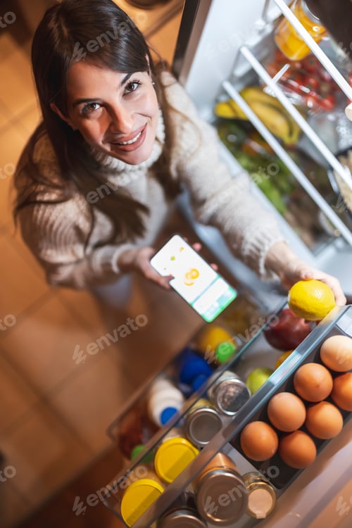 Preview: Woman using smart phone app for ordering groceries online