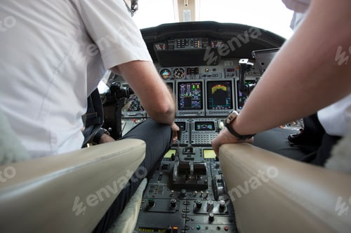 Preview: Male and female pilots in cockpit of private jet