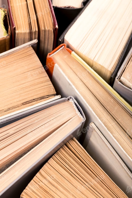 Preview: Books stacked close together in a cozy reading space filled with warm light