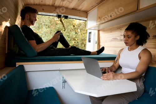 Preview: Couple working and relaxing in camper van