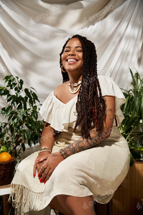 Preview: Radiant woman with braids enjoys a summer day surrounded by lush greenery