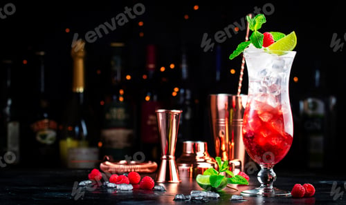 Preview: Raspberry lemonade cocktail or mocktail drink with raspberries, syrup, soda, lime, mint and ice