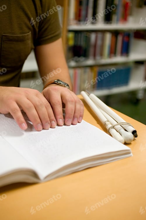 Preview: Young man reading braille