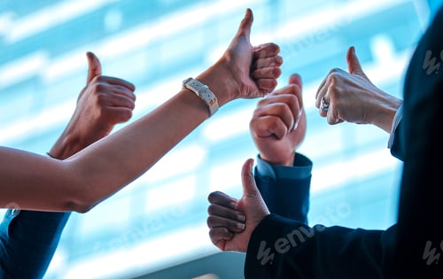 Preview: Shot of a group of young businesspeople giving each other a thumbs up against an urban background