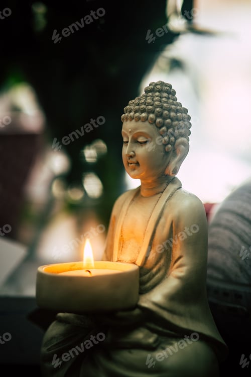 Preview: Vertical shot of Buddha statue holding a candle