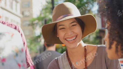 Preview: Close Up Of Smiling Young Woman Outdoors In City Wearing Floppy Hat