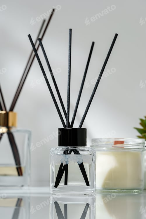 Preview: Elegant Home Fragrance Reed Diffuser Displayed Beside Scented Candles and Succulents