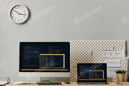 Preview: Office workplace setup with computer code on two screens