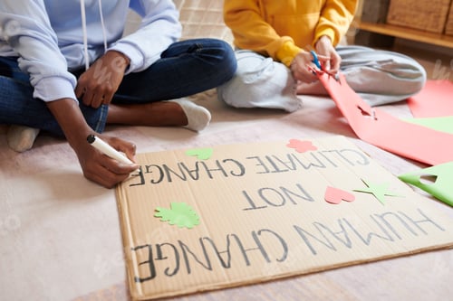 Preview: Girls Decorating Climate Change Placard