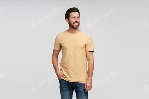 Preview: Smiling hispanic man looking away isolated on grey background