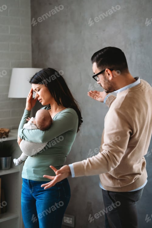 Preview: Frustrated Couple Arguing while Holding Baby at Home