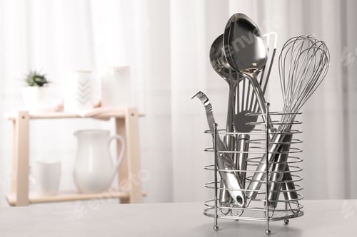 Preview: Holder with clean utensils on table in kitchen. Space for text