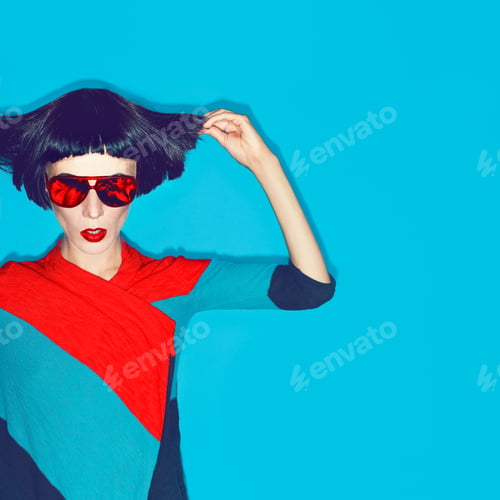 Preview: brunette model with fashion haircut and sunglasses on a blue bac