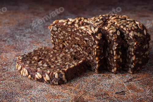 Preview: Fresh black bread with sunflower seeds on an old rusty table