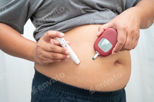 Preview: Asian woman injecting herself diabetes injecting insulin in stomach at home.