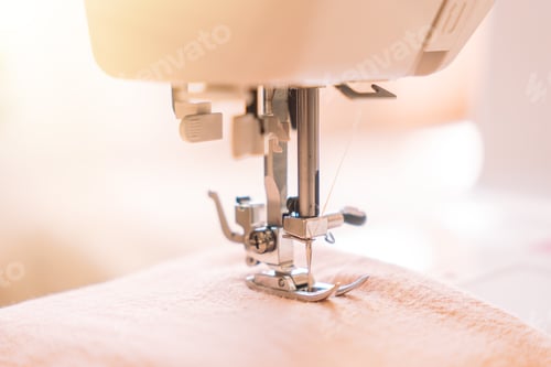 Preview: Close-up of a foot from a white sewing machine