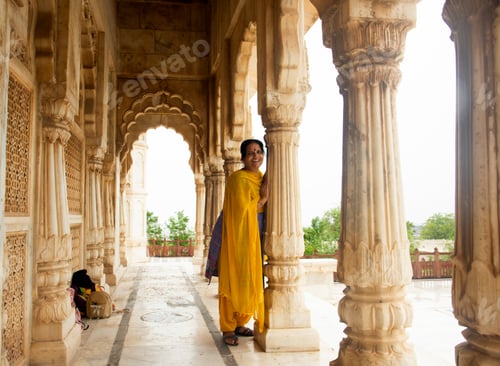 Preview: Indian woman standing between arches and Pillars.