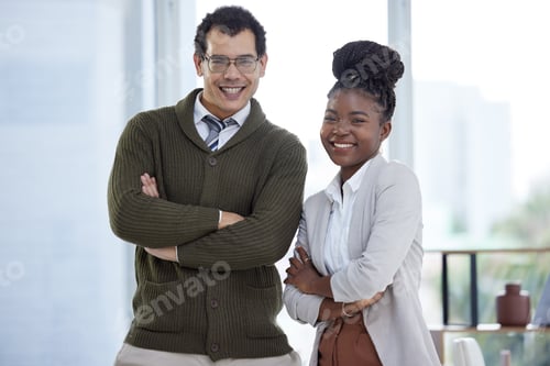 Preview: Portrait of two businesspeople standing together with their arms crossed in an office