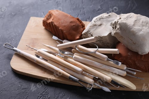 Preview: Clay and set of modeling tools on black table