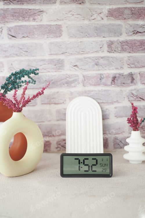 Preview: A Vibrant Decorative Arrangement Featuring a Modern Clock Surrounded by Lush Plants