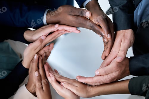 Preview: Cropped shot of a group of unrecognizable businesspeople joining their hands in solidarity