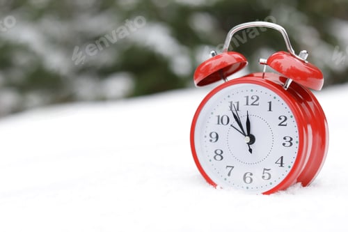 Preview: Red alarm clock on white snow outdoors. Space for text