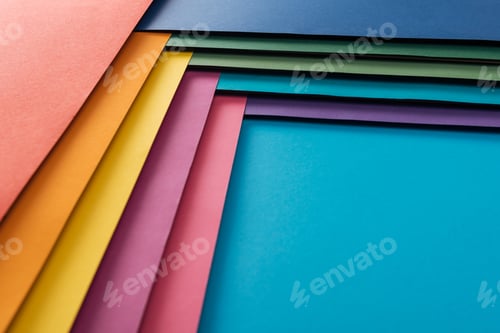 Preview: blank blue, burgundy, orange, green, yellow, pink and purple sheets of paper on blue background