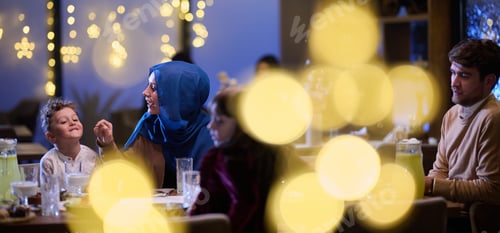 Preview: In a modern restaurant, an Islamic couple and their children joyfully await their iftar meal during