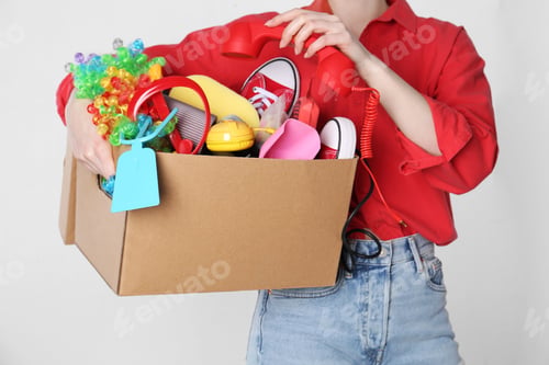Preview: Woman holding box of unwanted stuff on white background, closeup