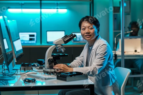 Preview: Young successful chinese female researcher with microscope