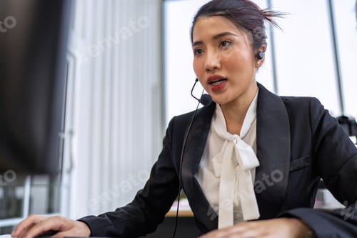Preview: Operator agent with headsets working in a call center giving help as a customer service officer
