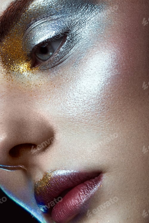 Preview: Beautiful girl with creative golden and silver glitter make-up. beauty face.