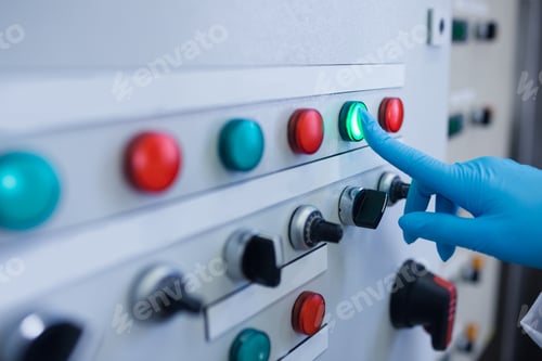 Preview: Hand pressing on green button of the machine in the factory