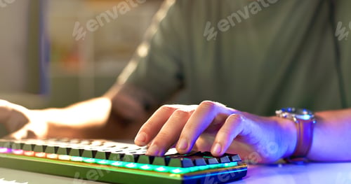 Preview: Man, hands and gamer with neon keyboard for esport, match or online tournament on desk at home. Clo