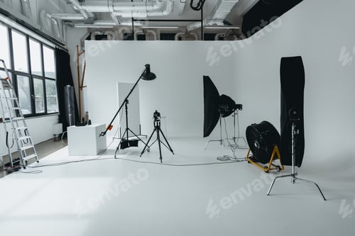Preview: photo studio with digital photo camera on tripod, lighting equipment and fan