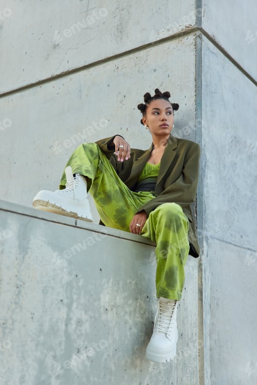 Preview: Vertical shot of hipster girl with bright makeup dressed in green fashionable clothes white boots po